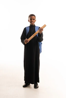 Sudanese Boy Student in Black Thobe with School Supplies
