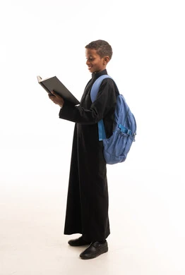 African Boy in Black Thobe Reading Book in Studio