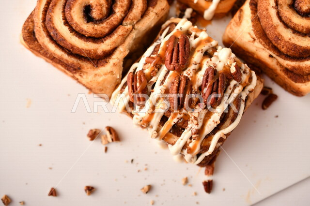 Close-up of delicious cinnamon rolls, cinnabon rolls, pastries, fresh baked goods, delicious dessert rolls, white background
