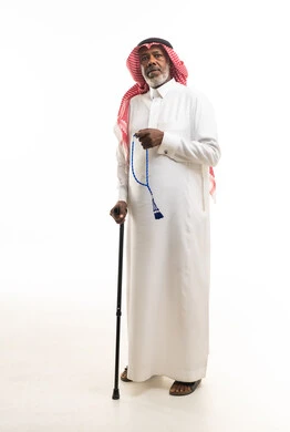 Elderly Saudi Man in Traditional Dress with Cane