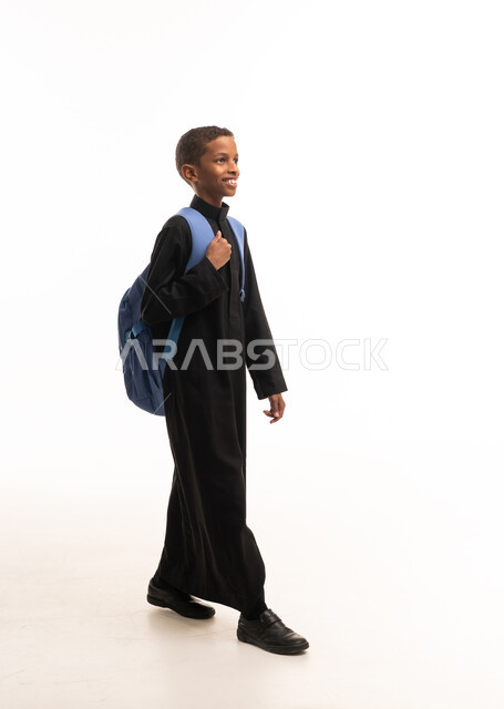 Saudi Schoolboy in Black Thobe with Blue Backpack