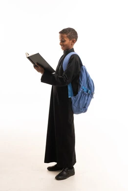 African-Arab Student in Black Thobe Reading a Book