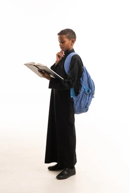 African Arab Schoolboy in Black Thobe Reading a Book