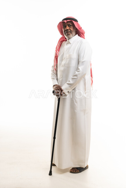 Elderly Saudi Man in Traditional Thobe with Walking Stick