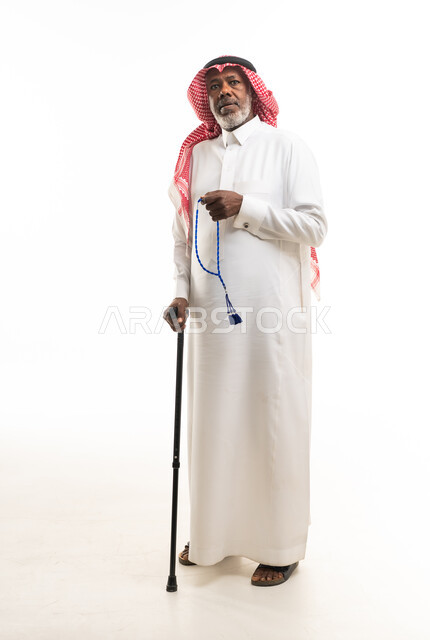 رجل سعودي مسن مع عصا مشي ومسبحة