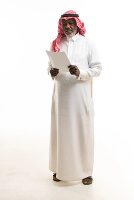 Senior Saudi Man Reading Business Document Studio Shot
