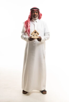 Saudi Man Holding Wooden House Model on White Background