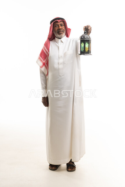 Saudi Man in Traditional Thobe Holding Ramadan Lantern