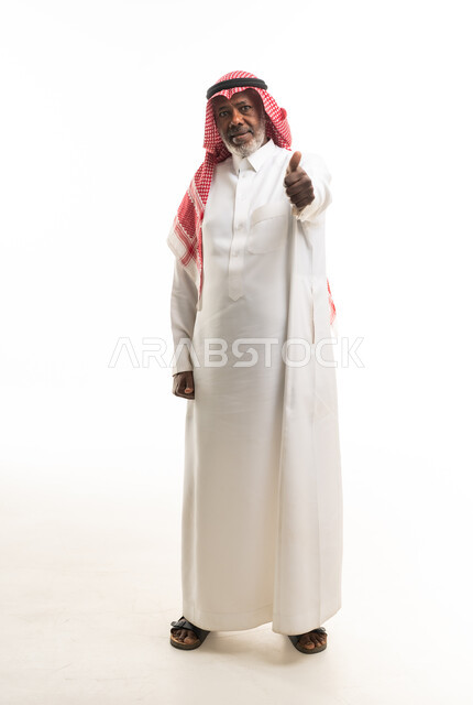 Elderly Saudi Man in Traditional Thobe Giving Thumbs Up