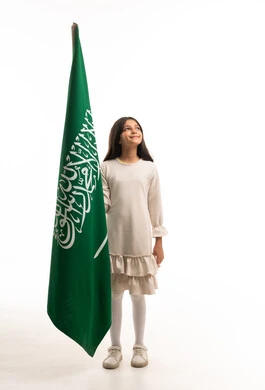 Saudi Girl Holding National Flag in Studio White Background