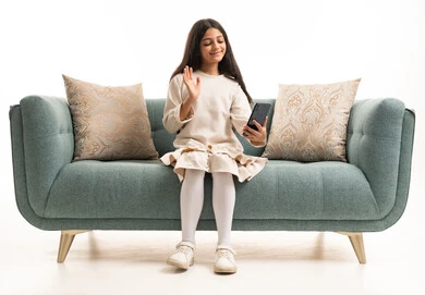 Saudi Girl Using Smartphone on Sofa Studio Shot