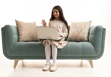 Saudi Girl Using Laptop on Sofa for Video Call