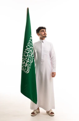Young Saudi Man with National Flag in White Studio