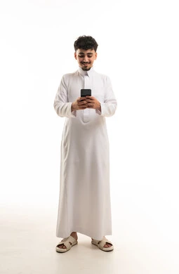 Saudi Man in Traditional Thobe Using Smartphone