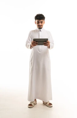 Saudi Man in Traditional Thobe Using Digital Tablet