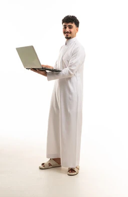 Saudi Man in Traditional Thobe Holding Laptop Studio Shot