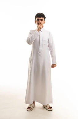 Saudi Man in White Thobe Making Silence Gesture