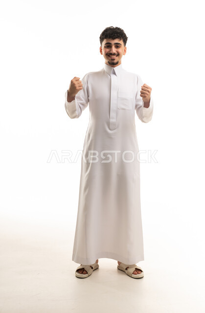 Young Saudi Man in White Thobe Celebrating Success