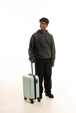 Saudi Man with Green Travel Suitcase in White Studio