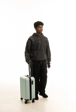 Saudi Male Youth with Travel Suitcase on White