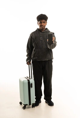 Saudi Traveler Holding Suitcase and Showing Smartphone