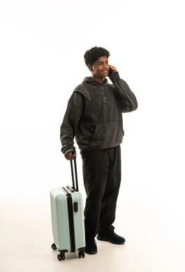 Black Male Traveler with Suitcase on White Background