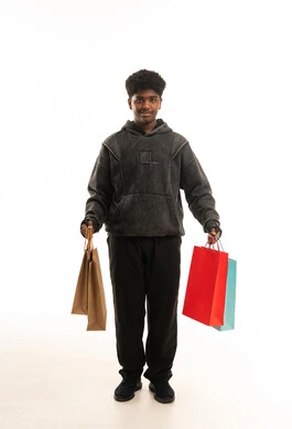 Young African Man Holding Shopping Bags on White Background
