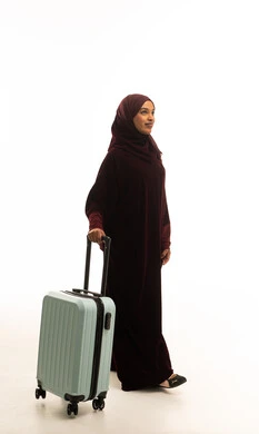 Emirati Woman in Abaya Walking with Suitcase