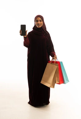 Saudi Woman Holding Shopping Bags and Smartphone Studio