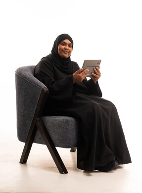 Saudi Woman in Abaya Using Tablet in Studio