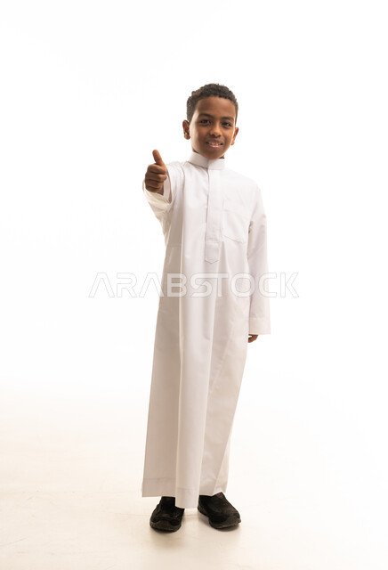Saudi Boy in White Thobe Giving Thumbs Up