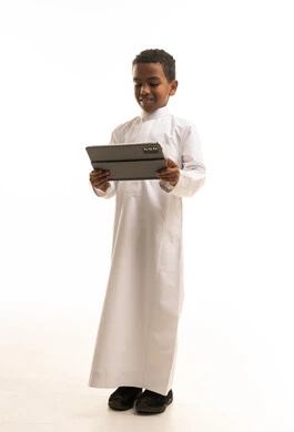 Saudi Boy in White Thobe Holding Tablet Studio Shot
