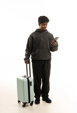Saudi Man with Suitcase and Smartphone on White Background