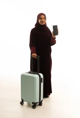 Saudi Woman with Suitcase and Smartphone on White Background