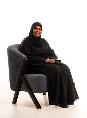 Saudi Woman in Black Abaya Sitting in Grey Armchair