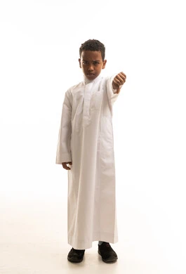 Saudi Boy in Thobe Giving Thumbs Down Gesture