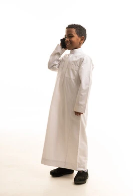 Saudi Boy in White Thobe Talking on Smartphone Studio