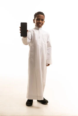 Saudi Boy in White Thobe Holding Smartphone Studio Shot