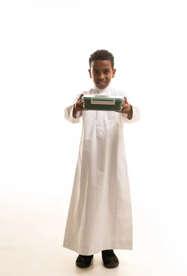 Saudi Boy in White Thobe Holding Green Lunch Box