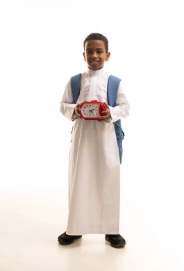 Saudi Schoolboy Holding Red Alarm Clock