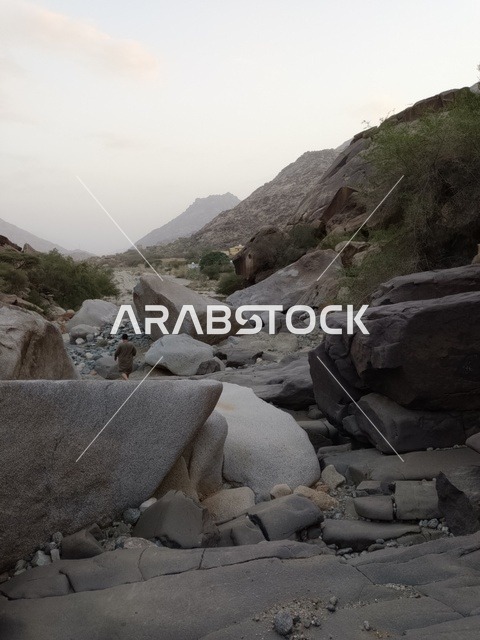 Man Walking in Al Baha Rocky Mountain Valley
