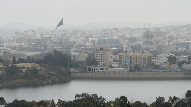 أفق مدينة أبها والبحيرة تحت سماء غائمة في عسير