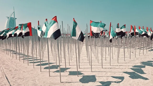 UAE Flags on Dubai Jumeirah Beach with Burj Al Arab