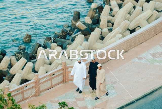 Omani Men Walking on Coastal Promenade Sultanate of Oman