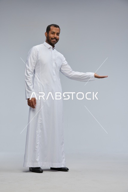 Saudi Man in White Thobe Making Presenting Gesture