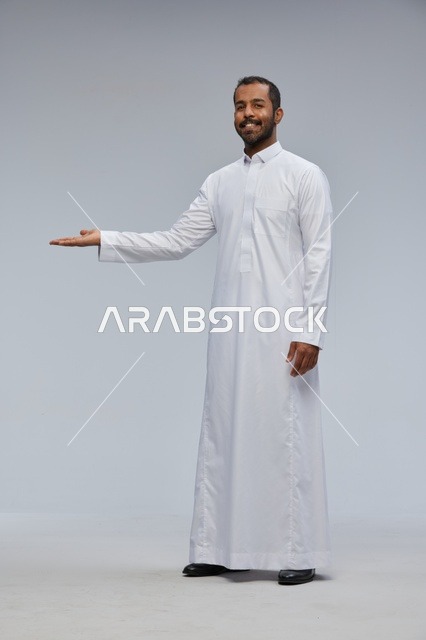 Saudi Man in White Thobe Presenting with Gesture