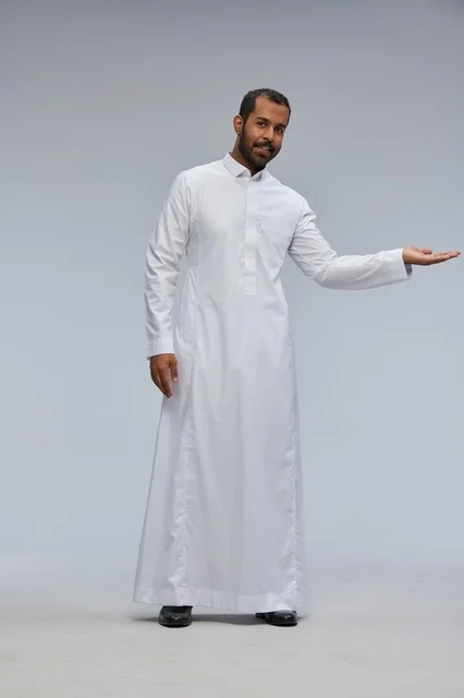 Saudi Man in White Thobe Presenting on Studio Background