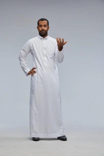 Saudi Man in Traditional White Thobe Gesturing in Studio