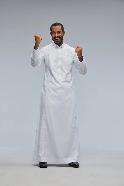 Saudi Man in Traditional White Thobe Celebrating Success