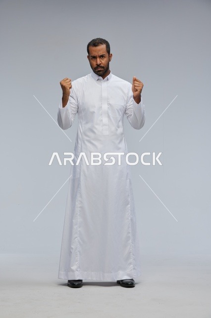 Saudi Man in White Thobe with Clenched Fists